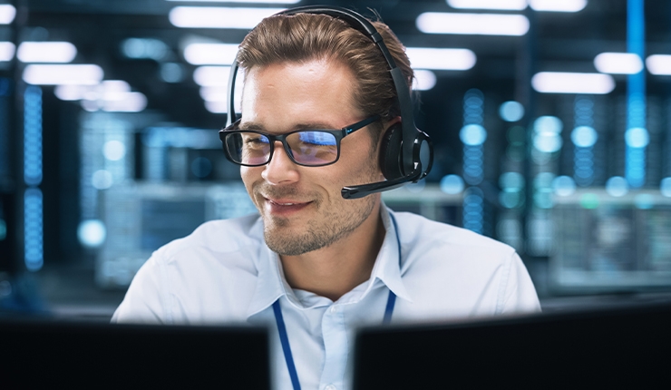 man looking at two monitors